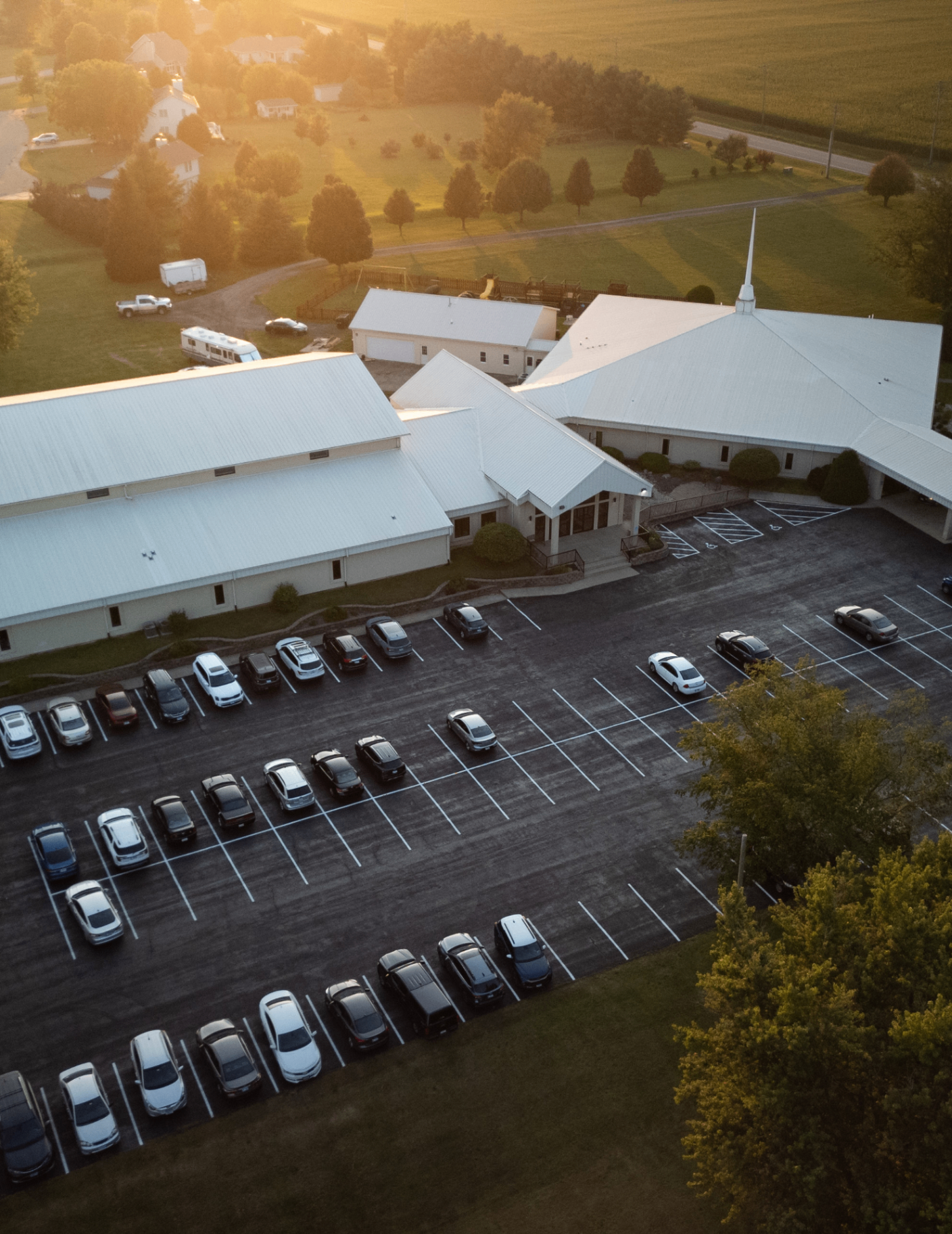 Aerial view of Calvary Lighthouse Church campus at sunset